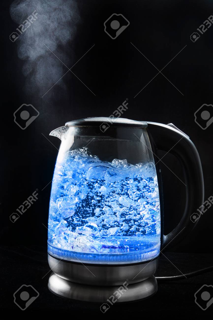 Boiling Glass Kettle With Blue Light On A Black Background Steam