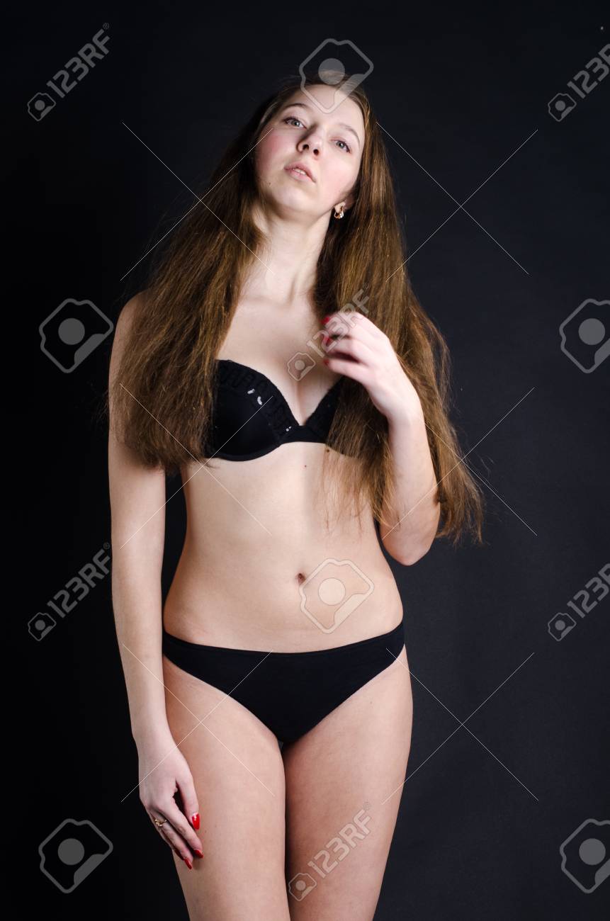 A Young Girl In Sexy Black Underwear On A Black Background Stock Photo,  Picture and Royalty Free Image. Image 53619233.