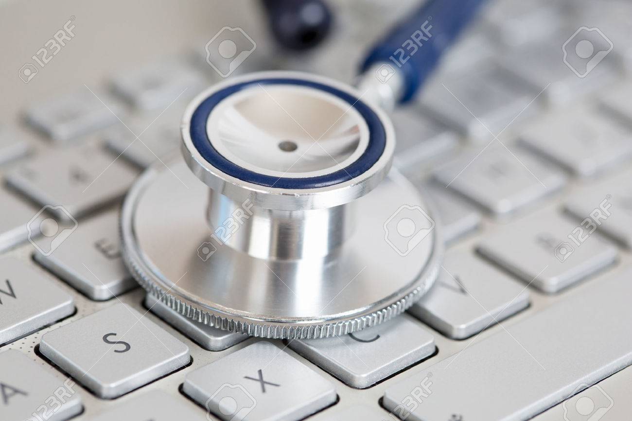 Stethoscope head lying on silver keyboard closeup. Medical concept. Modern medicine and high tech equipment concept - 46777515 Stethoscope head lying on silver keyboard closeup. Medical concept. Modern medicine and high tech equipment concept - 46777515