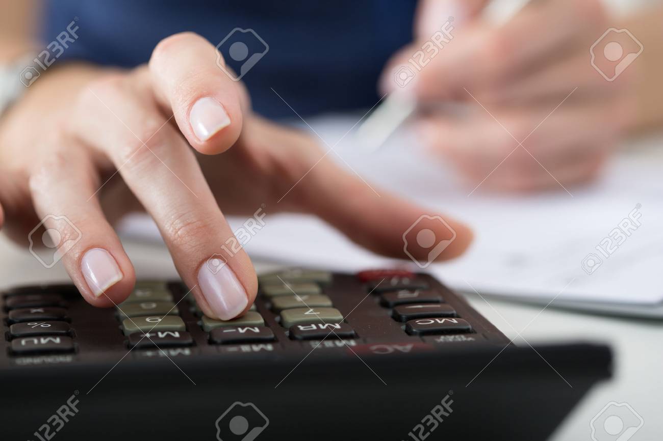 Close up of female accountant or banker making calculations. Savings, finances and economy concept - 46777695 Close up of female accountant or banker making calculations. Savings, finances and economy concept - 46777695