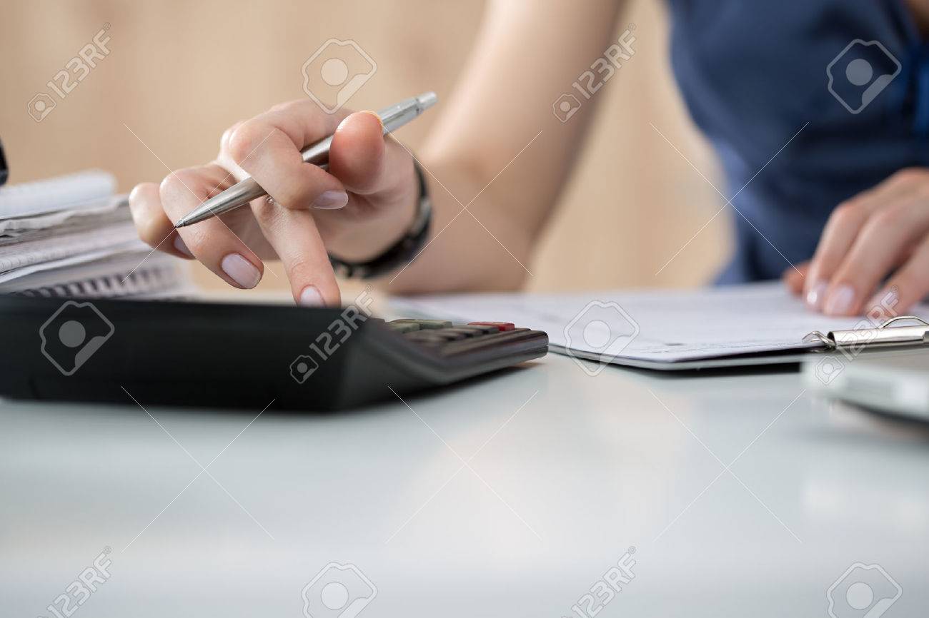 Close up of female accountant or banker making calculations. Savings, finances and economy concept. Copy space - 46777847 Close up of female accountant or banker making calculations. Savings, finances and economy concept. Copy space - 46777847