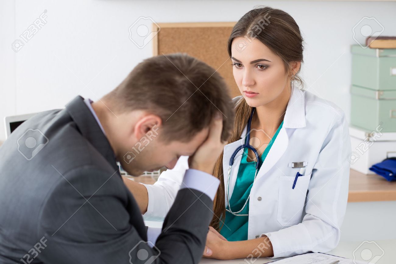 Friendly female medicine doctor's holding male patient's hand supporting him. Bad news, stress and depression concept. - 47974722 Friendly female medicine doctor's holding male patient's hand supporting him. Bad news, stress and depression concept. - 47974722