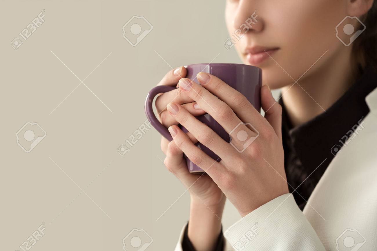 Close up of young beautiful woman hands holding hot cup of coffee or tea. Morning coffee, cold season, office coffee break or coffee lover concept. - 59198382 Close up of young beautiful woman hands holding hot cup of coffee or tea. Morning coffee, cold season, office coffee break or coffee lover concept. - 59198382