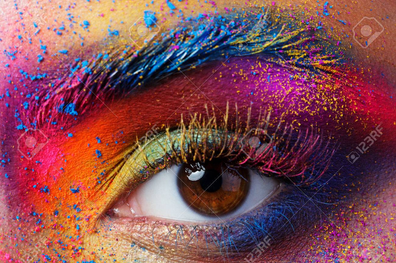 Close up view of female eye with bright multicolored fashion makeup. Holi indian color festival inspired. Studio macro shot - 68488186 Close up view of female eye with bright multicolored fashion makeup. Holi indian color festival inspired. Studio macro shot - 68488186