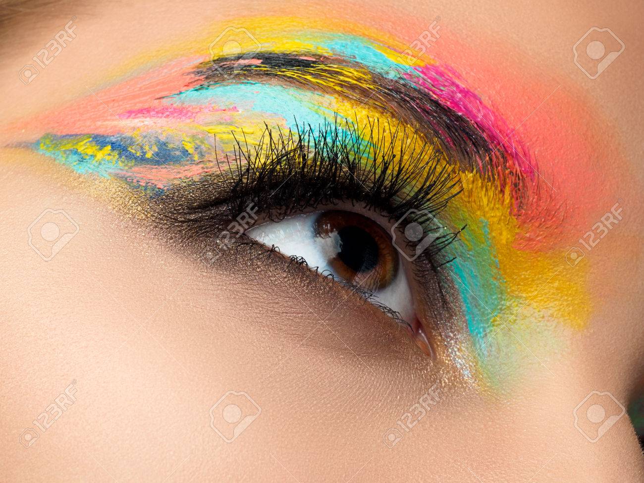 Close up of blue woman eye with beautiful brown with red and orange shades smokey eyes makeup. Modern fashion make up. - 72560482 Close up of blue woman eye with beautiful brown with red and orange shades smokey eyes makeup. Modern fashion make up. - 72560482
