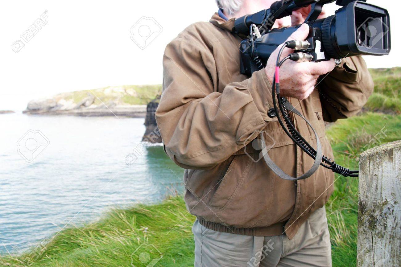 a cameraman filming on the cliff edge in ballybunion ireland - 3729678 a cameraman filming on the cliff edge in ballybunion ireland - 3729678