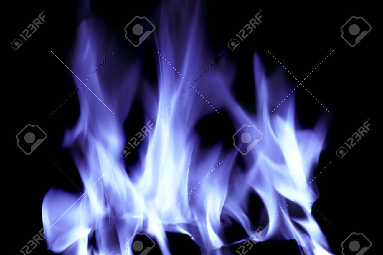 bright blue flames on an open fire that give that warm feeling stock