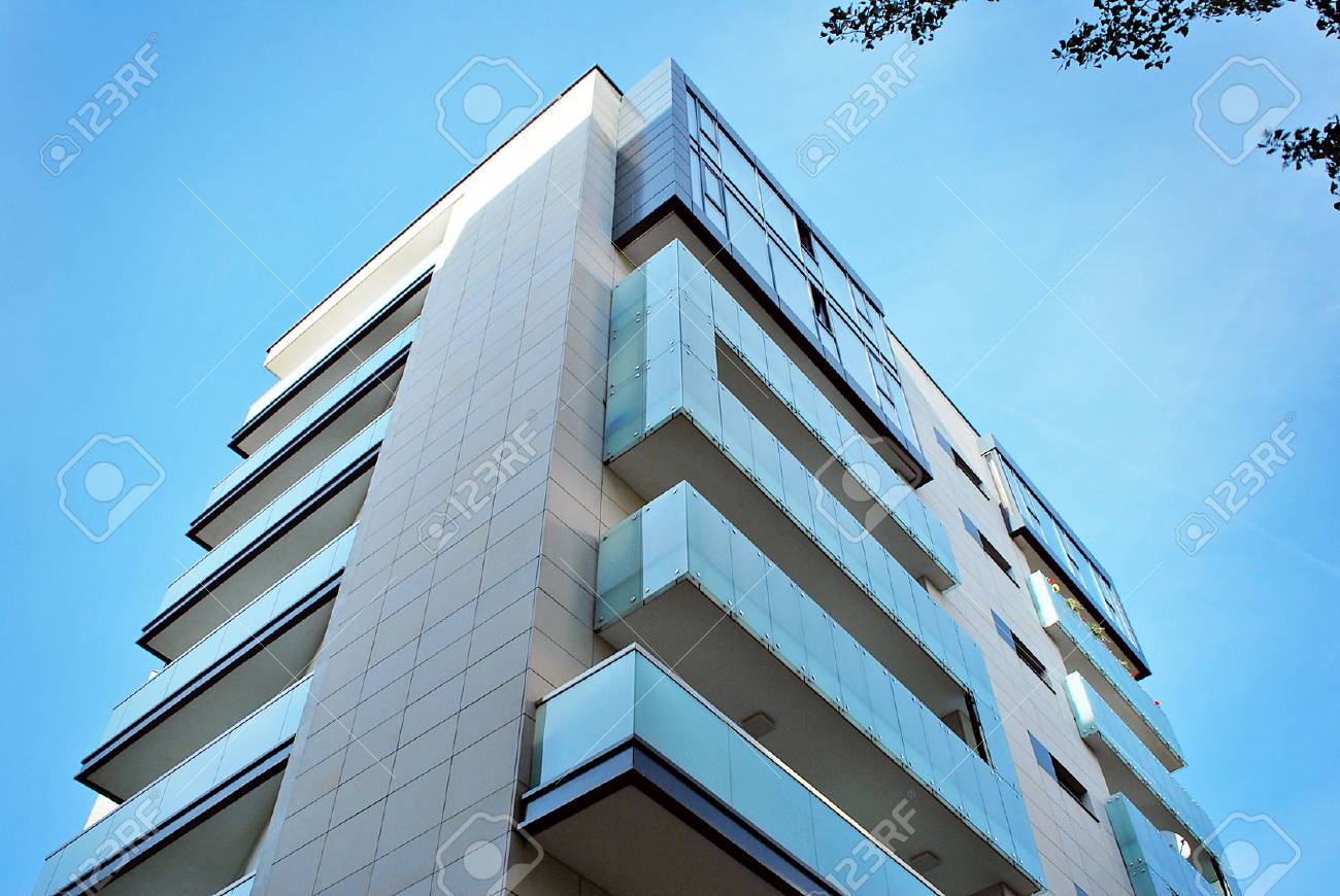 Modern, Luxury Apartment Building against blue sky - 87477242 Modern, Luxury Apartment Building against blue sky - 87477242