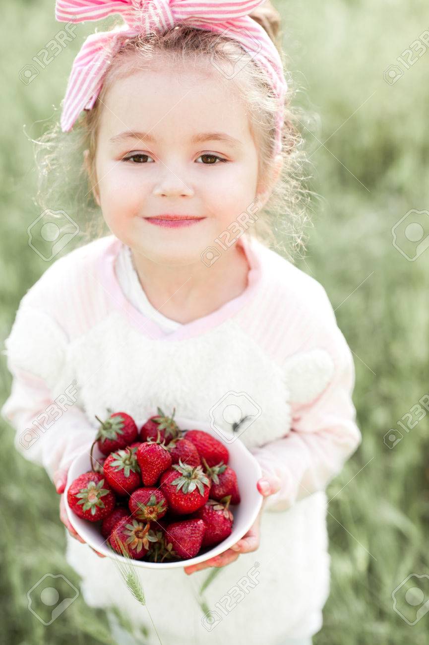 Smiling Baby Girl 4-5 Year Old Holding Bowl With Strawberry ...
