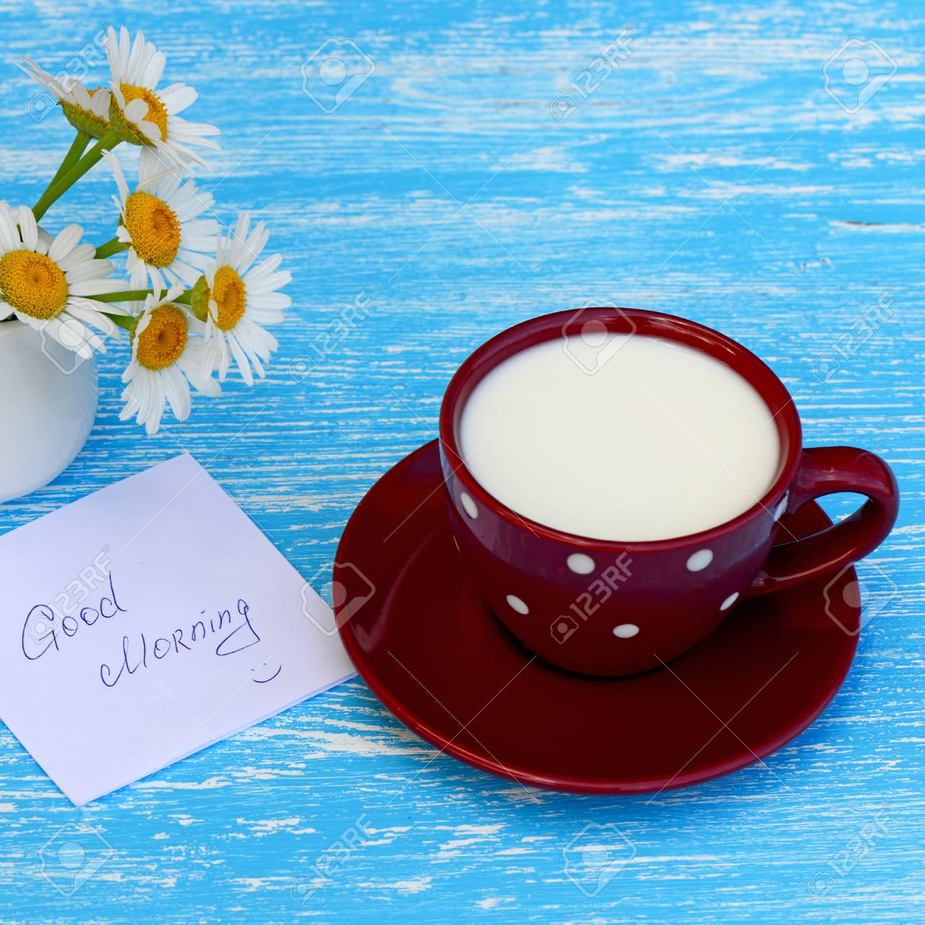 Daisy Flowers And Cup Of Milk With Good Morning Note On Rustic