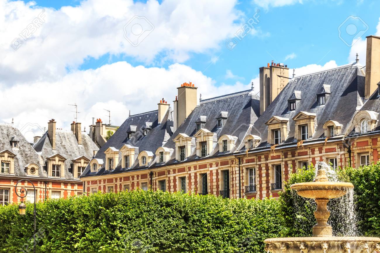 historic buildings with fountain at the famous place des vosges