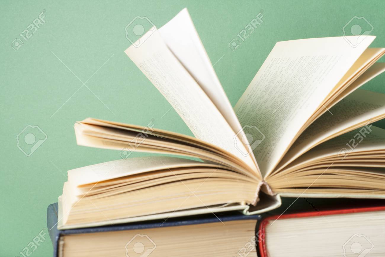 open book hardback books on wooden table education background