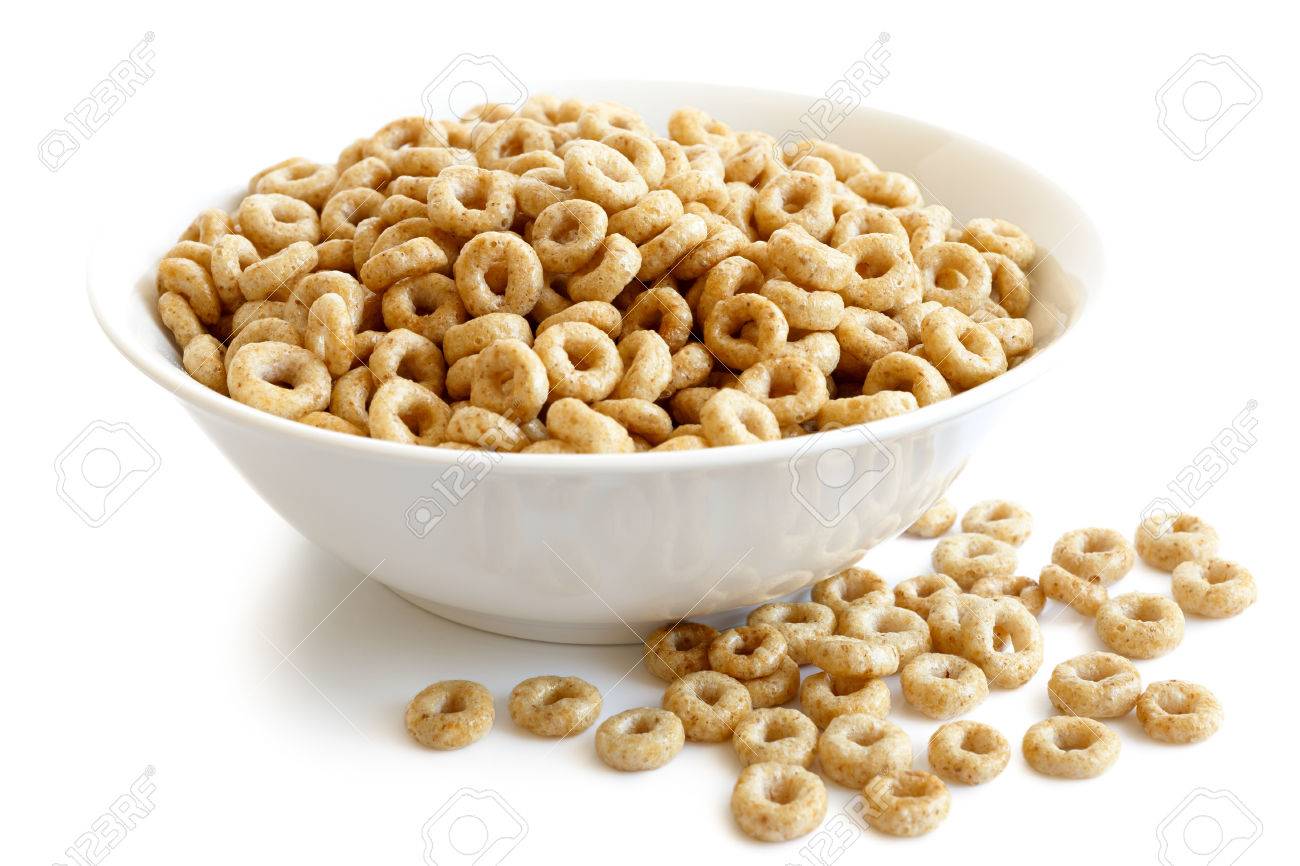 bowl of honey cheerios isolated on white spilled cheerios stock