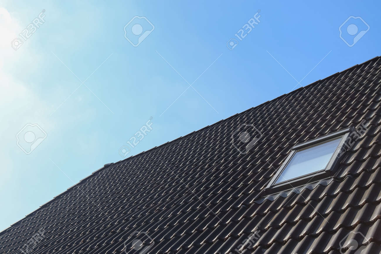 Roof window in velux style with black roof tiles - 169911347 Roof window in velux style with black roof tiles - 169911347
