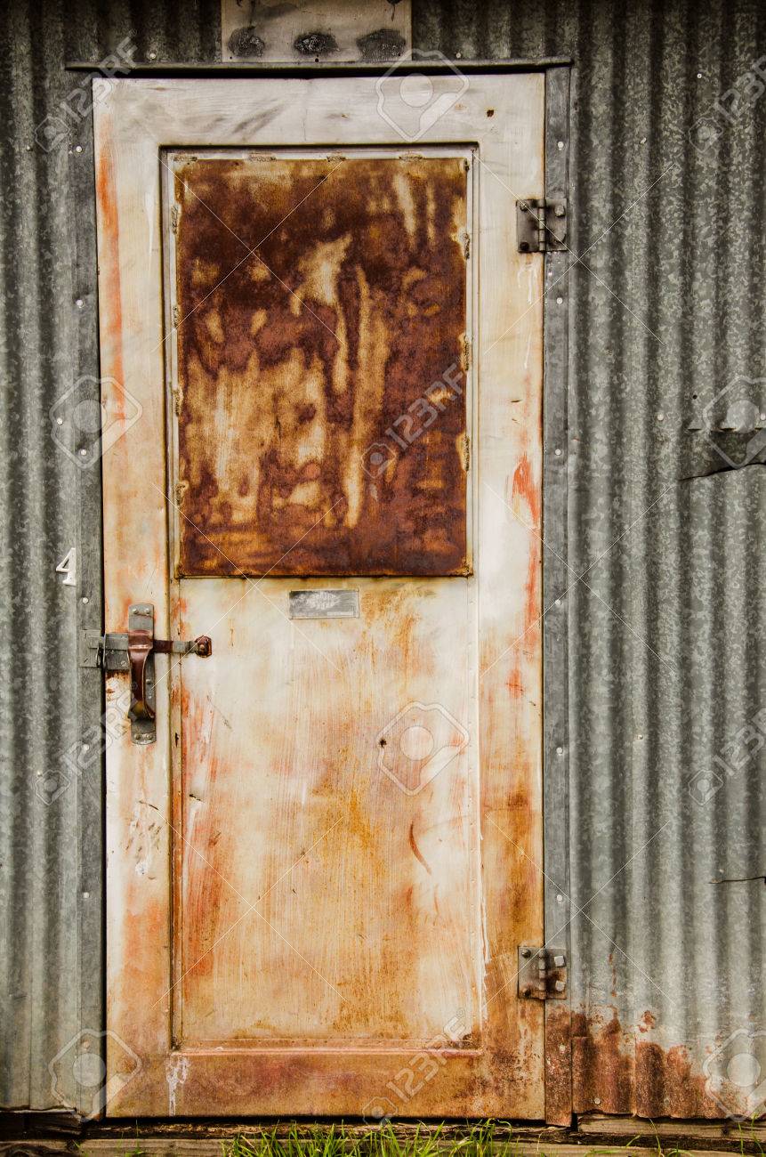 Rusty Metal Door rusty metal door and metal exterior wall on local farm stock photo Rusty Metal Door rusty metal door and metal exterior wall on local farm stock photo