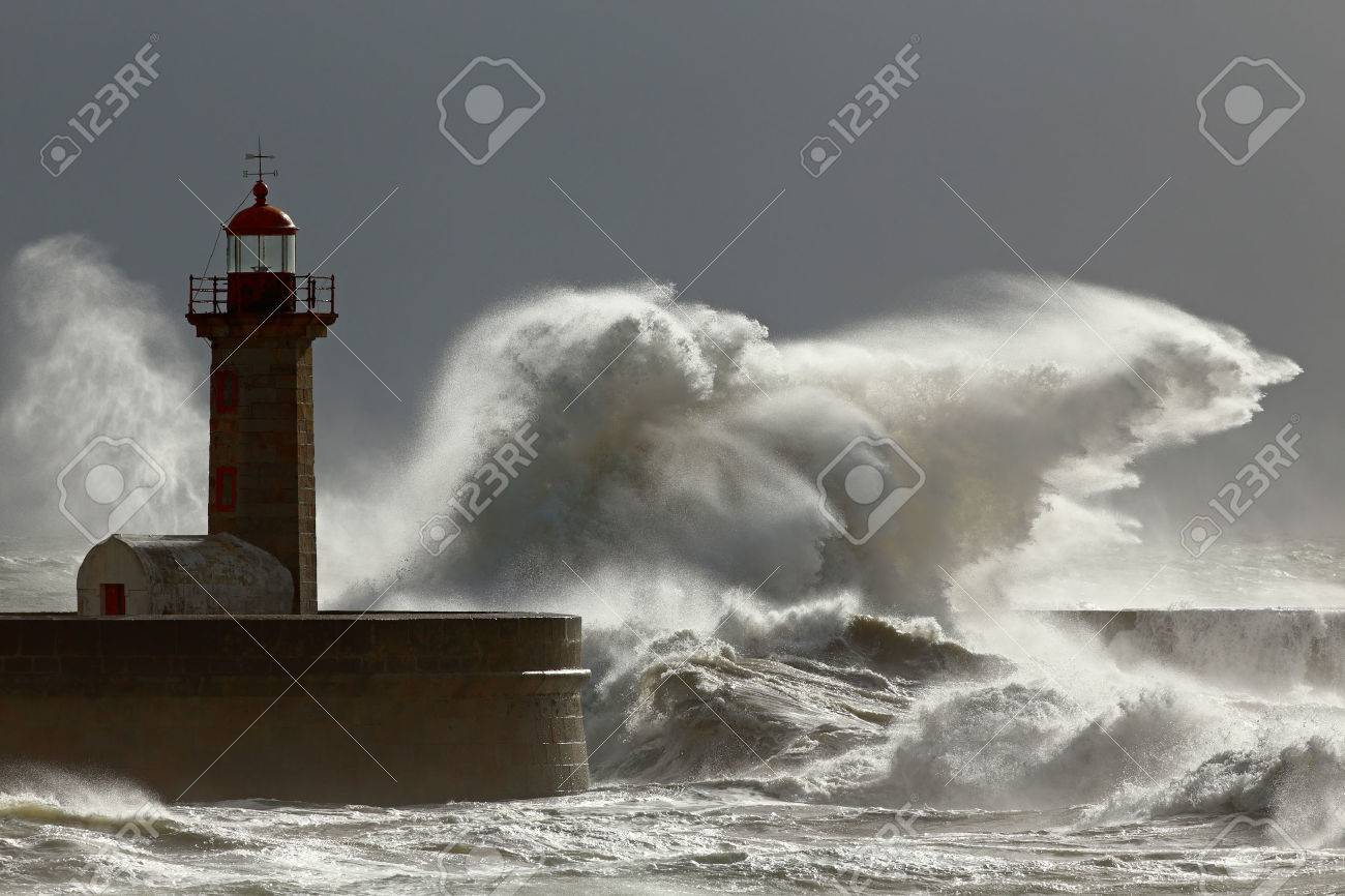 Big stormy waves against lighthouse with interesting light. Porto, Portugal. Low edition photo. - 33678369 Big stormy waves against lighthouse with interesting light. Porto, Portugal. Low edition photo. - 33678369