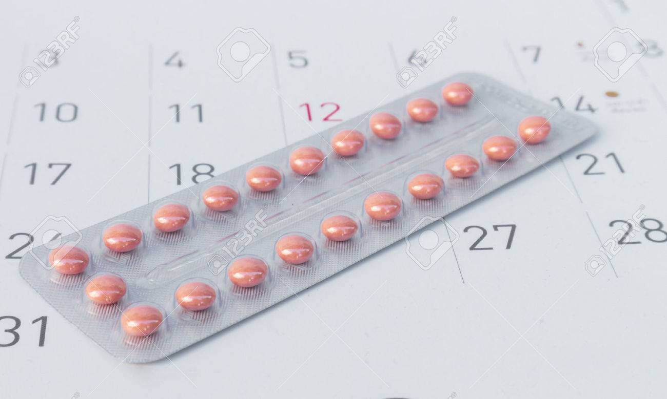 close up birth control pill with date of calendar background pill calendar