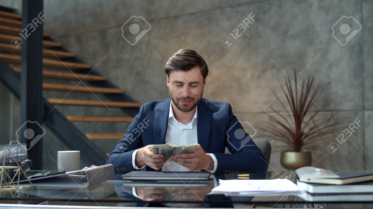 Happy businessman throwing money away in modern office. Portrait of successful business man counting money at workplace. Joyful man rejoicing good deal in office in slow motion - 162267989 Happy businessman throwing money away in modern office. Portrait of successful business man counting money at workplace. Joyful man rejoicing good deal in office in slow motion - 162267989