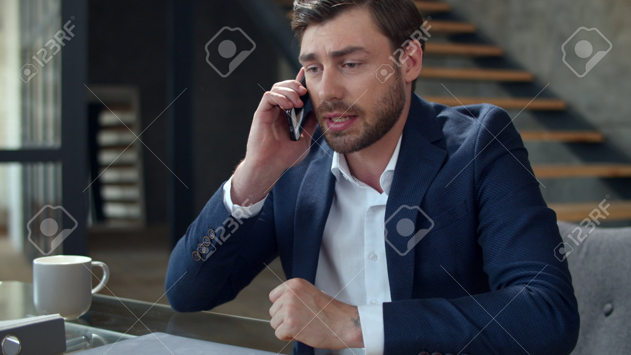 Portrait of angry businessman talking phone at home office emotionally. Closeup stressed business man calling on cell phone in slow motion. Frustrated man having problem on workplace. - 162270267 Portrait of angry businessman talking phone at home office emotionally. Closeup stressed business man calling on cell phone in slow motion. Frustrated man having problem on workplace. - 162270267