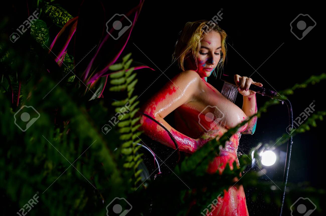 A Woman With Very Large Breasts Washes Body Paint In The Shower. Paint  Flows Down The Naked Body Of A Girl In The Bathroom. Stock Photo, Picture  and Royalty Free Image. Image