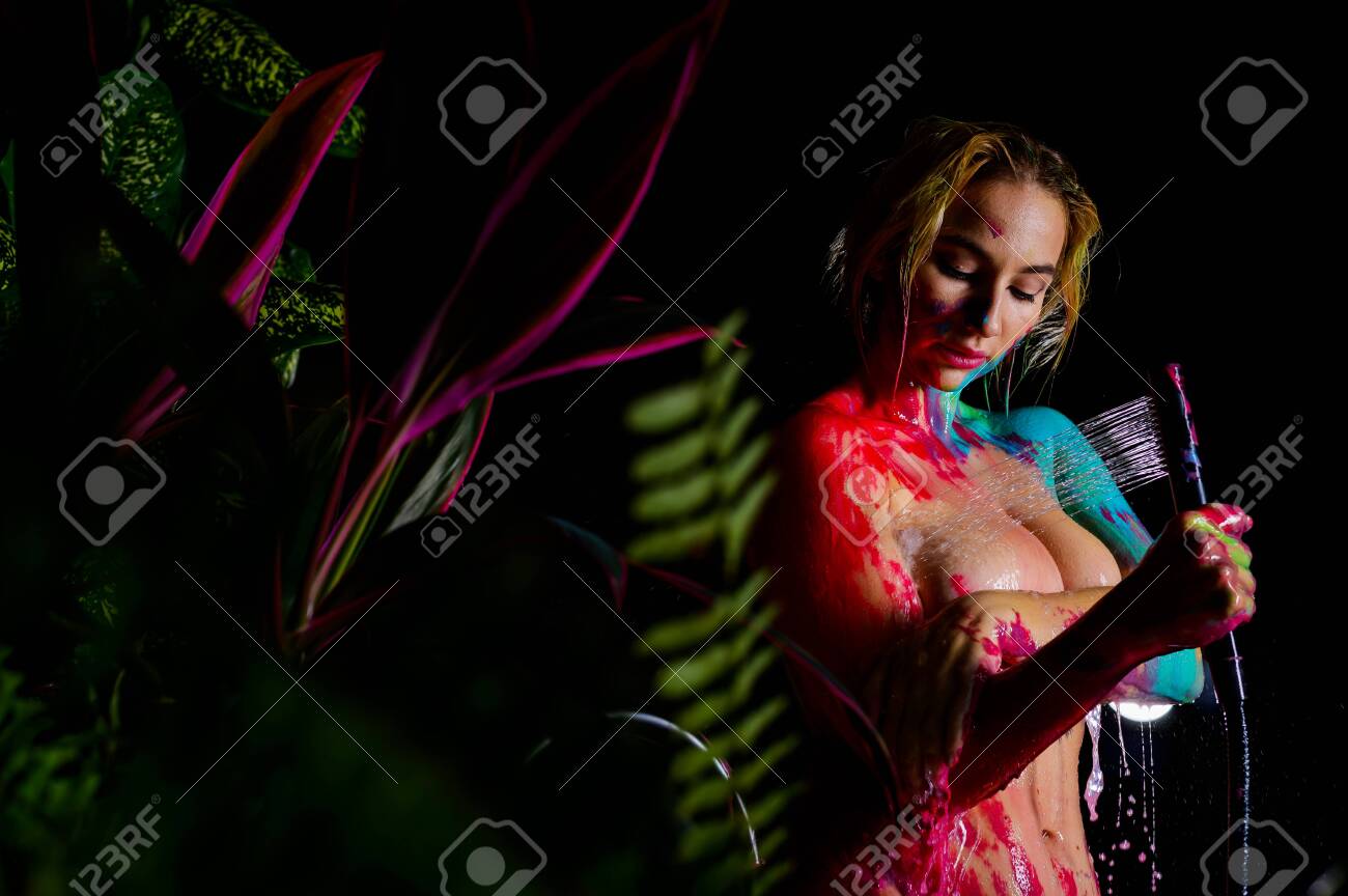 A Woman With Very Large Breasts Washes Body Paint In The Shower. Paint Flows Down The Naked Body Of A Girl In The Bathroom