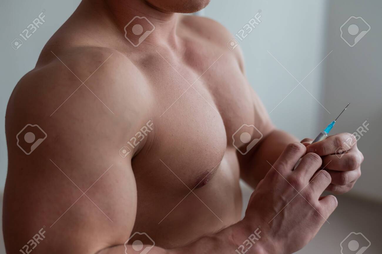 Primer Plano De Un Torso Masculino Desnudo. El Culturista Sin Camisa  Irreconocible Se Pone Una Inyección De Testosterona. El Atleta Sin Rostro  Se Droga. Fotos, retratos, imágenes y fotografía de archivo libres