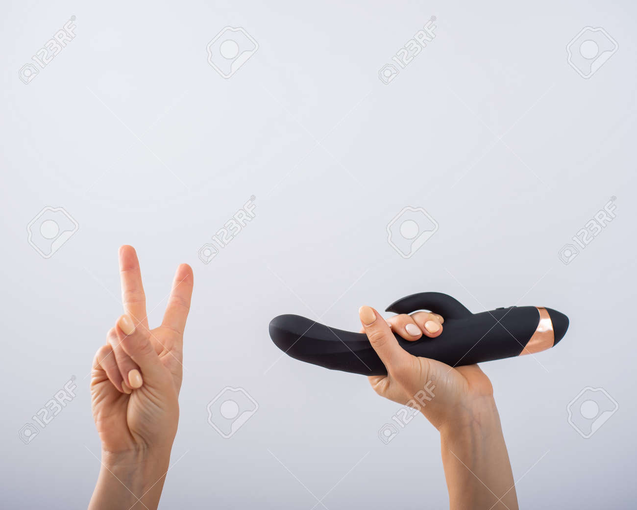 Faceless Woman Holding Black Dildo And