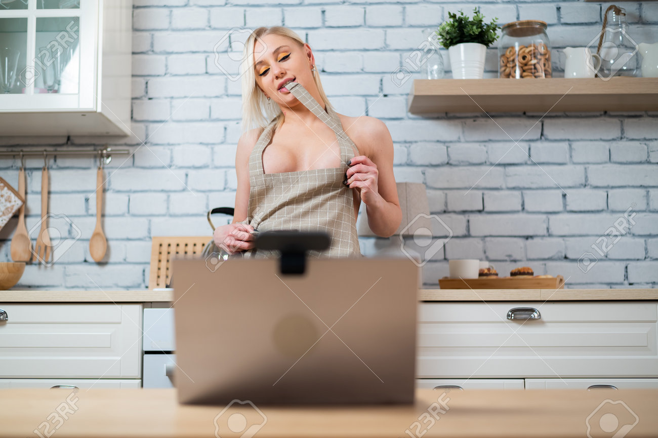 Sexy Woman In An Apron Has Online Sex In The Kitchen. Stock Photo, Picture  and Royalty Free Image. Image 179834606.