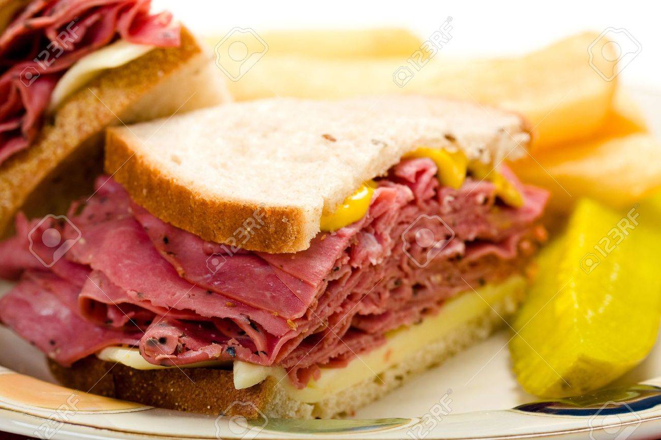 Pastrami Sandwich With Thick French Fries And Pickle Stock ...