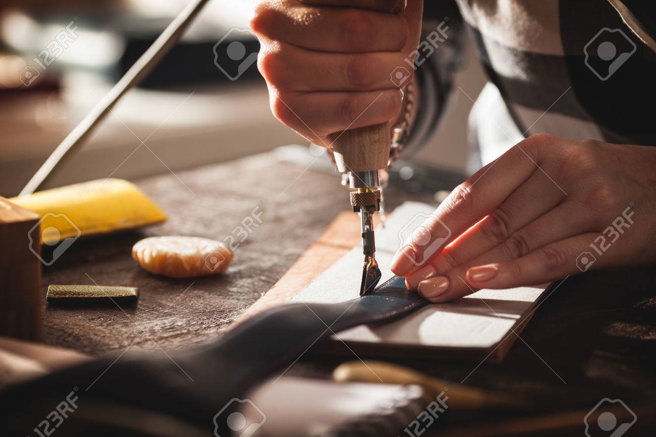 Leather handbag craftsman at work in a workshop - 62612777 Leather handbag craftsman at work in a workshop - 62612777