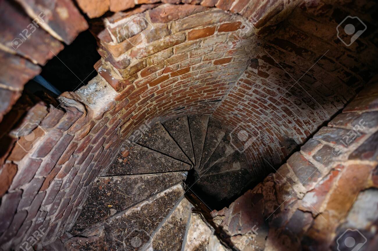 Old Spiral Staircase Inside Red Brick Tower, Upside View. Stock Old Spiral Staircase Inside Red Brick Tower, Upside View. Stock