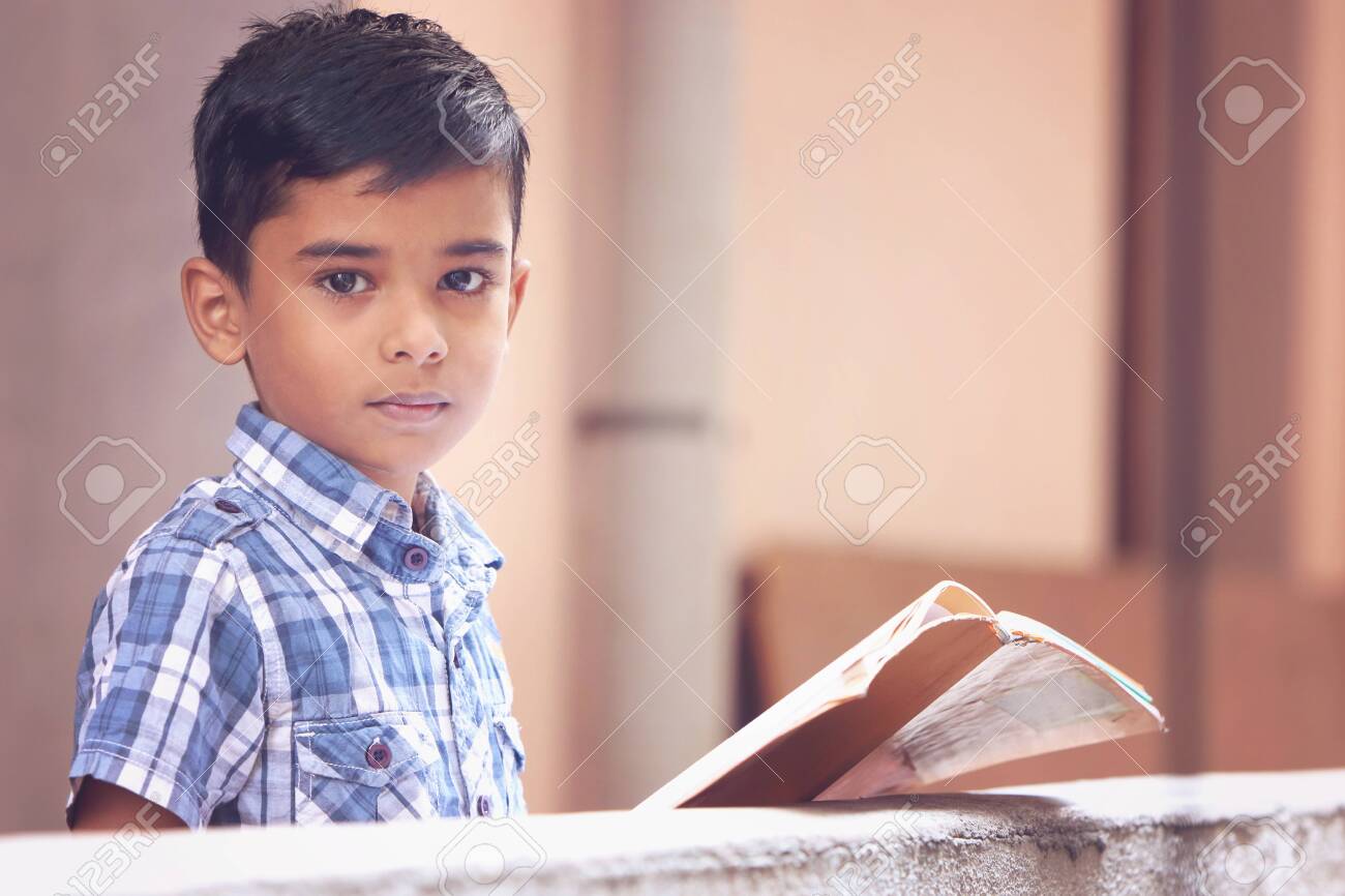 Portrait Of Indian Little Boy Posing To Camera With School Text Book Stock  Photo, Picture and Royalty Free Image. Image 129513108., image size:1300x866