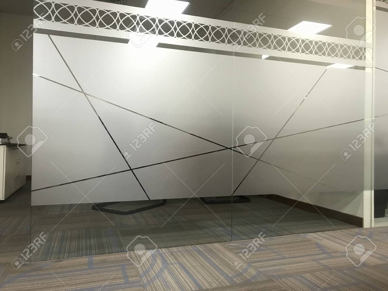 Images of Full height glass wall partitions for an office meeting room or manager room with an sticker of Frosted film for privacy of people for discussing in office interiors - 144621110 Images of Full height glass wall partitions for an office meeting room or manager room with an sticker of Frosted film for privacy of people for discussing in office interiors - 144621110
