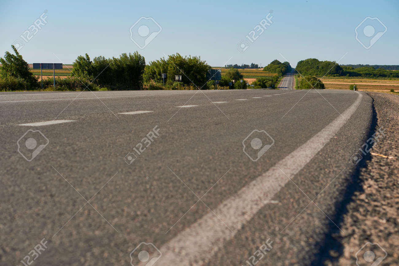 soft focus asphalt road surface with white markings close-up from the low shot. blured country road and field with forest in summer. High quality photo. Travel, tehnology, nature comcept. - 166761871 soft focus asphalt road surface with white markings close-up from the low shot. blured country road and field with forest in summer. High quality photo. Travel, tehnology, nature comcept. - 166761871