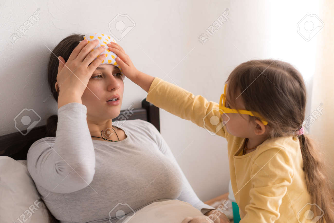 little girl wearing uniform playing doctor, nurse with young mum, nanny in bedroom, checking mother throat, measures temperature, take care, family spend leisure time at home together role play game - 167137583 little girl wearing uniform playing doctor, nurse with young mum, nanny in bedroom, checking mother throat, measures temperature, take care, family spend leisure time at home together role play game - 167137583