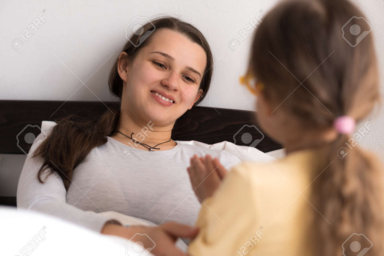little girl wearing uniform playing doctor, nurse with young mum, nanny in bedroom, checking mother throat, measures temperature, take care, family spend leisure time at home together role play game - 167137737 little girl wearing uniform playing doctor, nurse with young mum, nanny in bedroom, checking mother throat, measures temperature, take care, family spend leisure time at home together role play game - 167137737