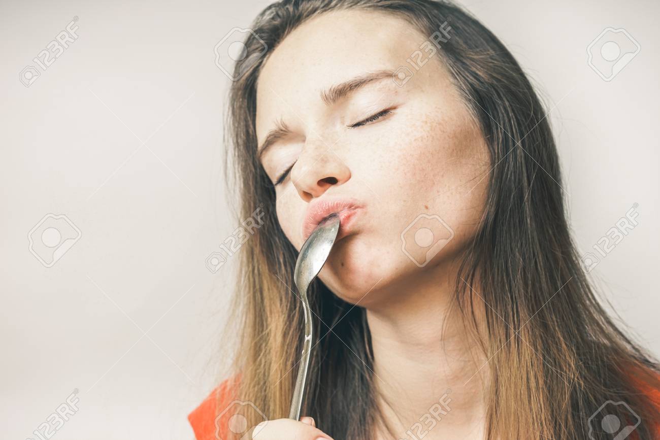 Hangry Woman Eating Spoon In An Orange T Shirt Her Eyes Are