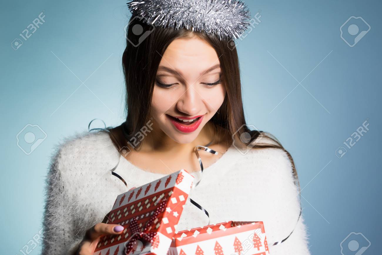 happy young girl received a gift for the new year looks in the gift