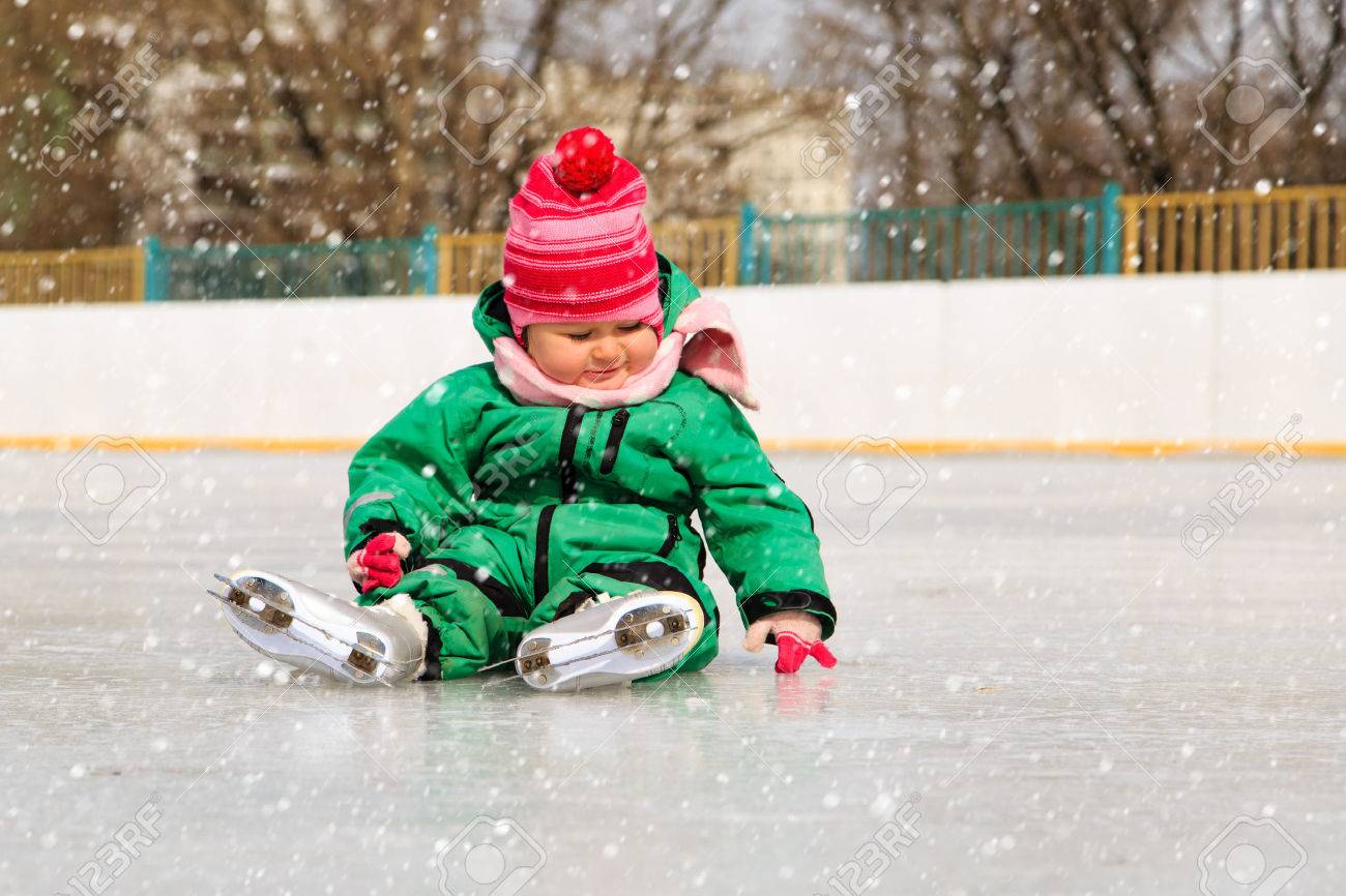 cute little girl sitting on ice with skates after the fall - 45613871 cute little girl sitting on ice with skates after the fall - 45613871
