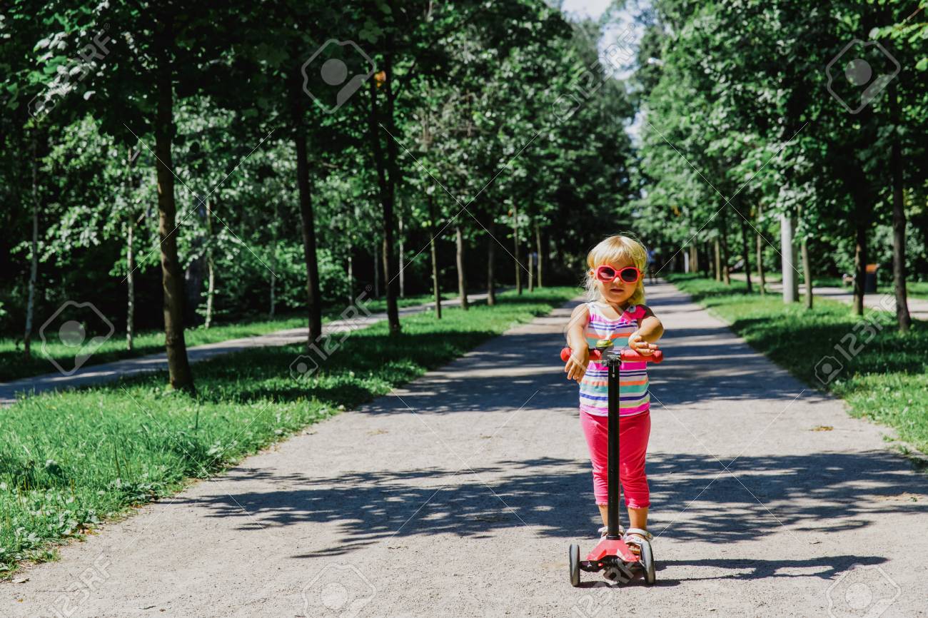 little girl riding scooter