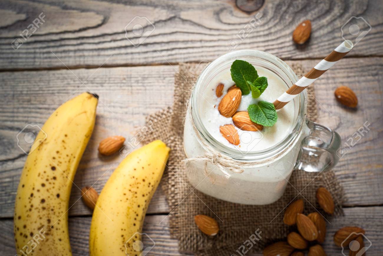 Shake from almond milk, banana and coconut in a mason mug. Dairy free. - 54514175 Shake from almond milk, banana and coconut in a mason mug. Dairy free. - 54514175