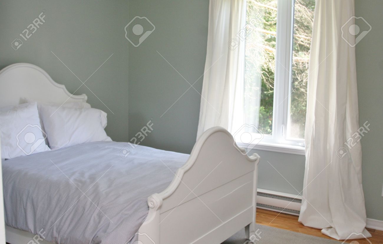 Grey Bedroom With White Bed And Pillows And White Curtains