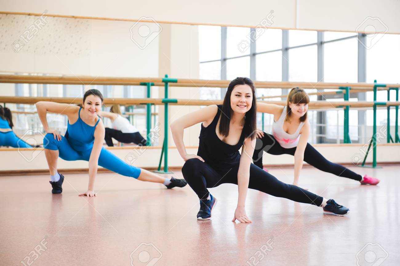 Group of people at the gym in a stretching class - 121816814 Group of people at the gym in a stretching class - 121816814