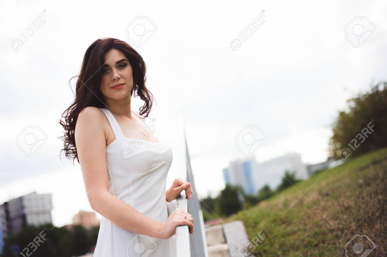 beautiful young girl in a white dress on the stairs - 122173930 beautiful young girl in a white dress on the stairs - 122173930