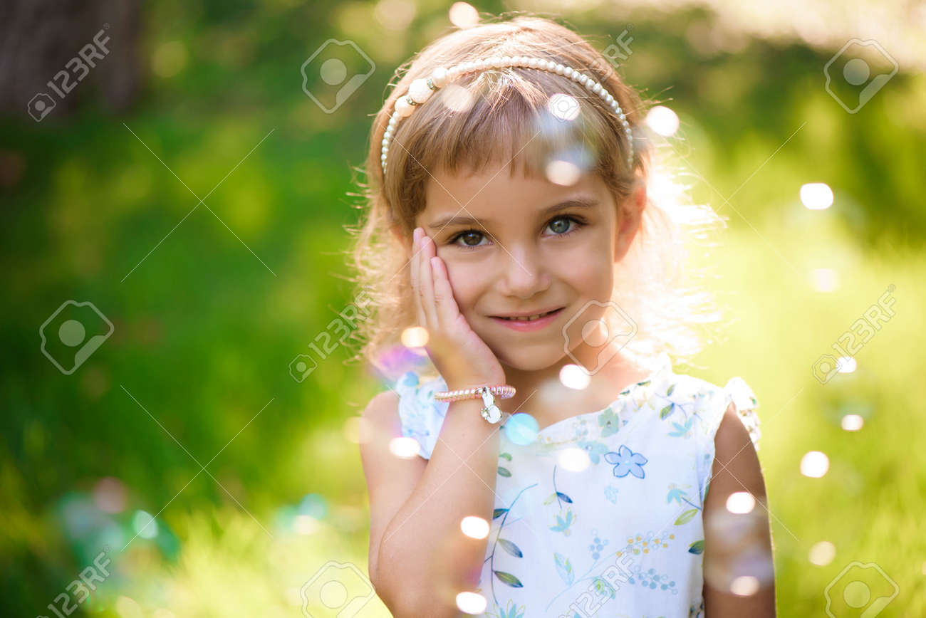 Sweet, happy, smiling five year old girl laying on a grass - 166727311 Sweet, happy, smiling five year old girl laying on a grass - 166727311