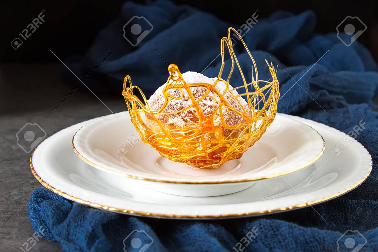 Italian Dessert Is Profiterole With Cream And Caramel Decoration