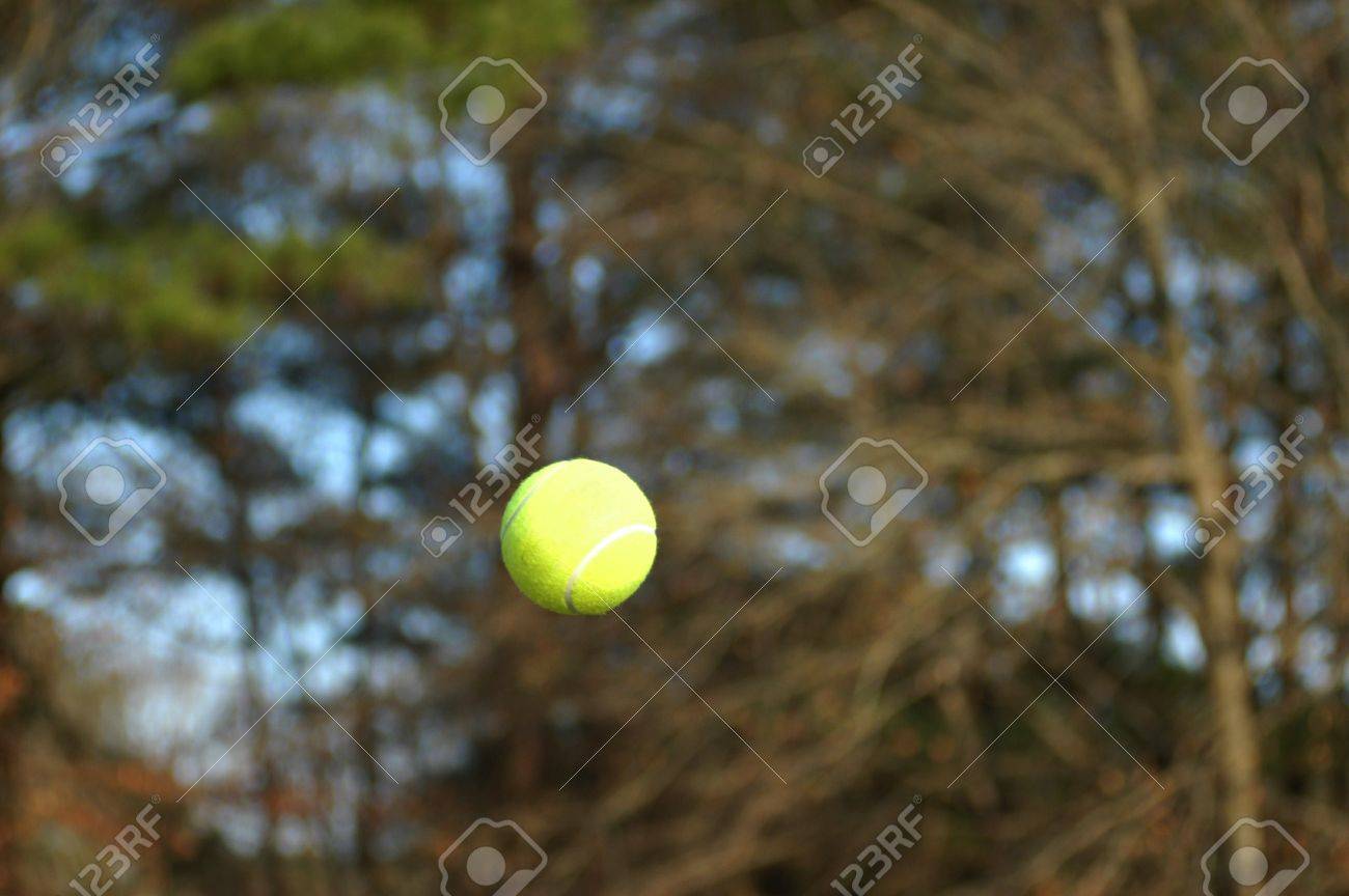 テニス ボールは テニスの試合中に空気を通って飛ぶ フライトがキャプチャされ ボールが空中で固定されています の写真素材 画像素材 Image