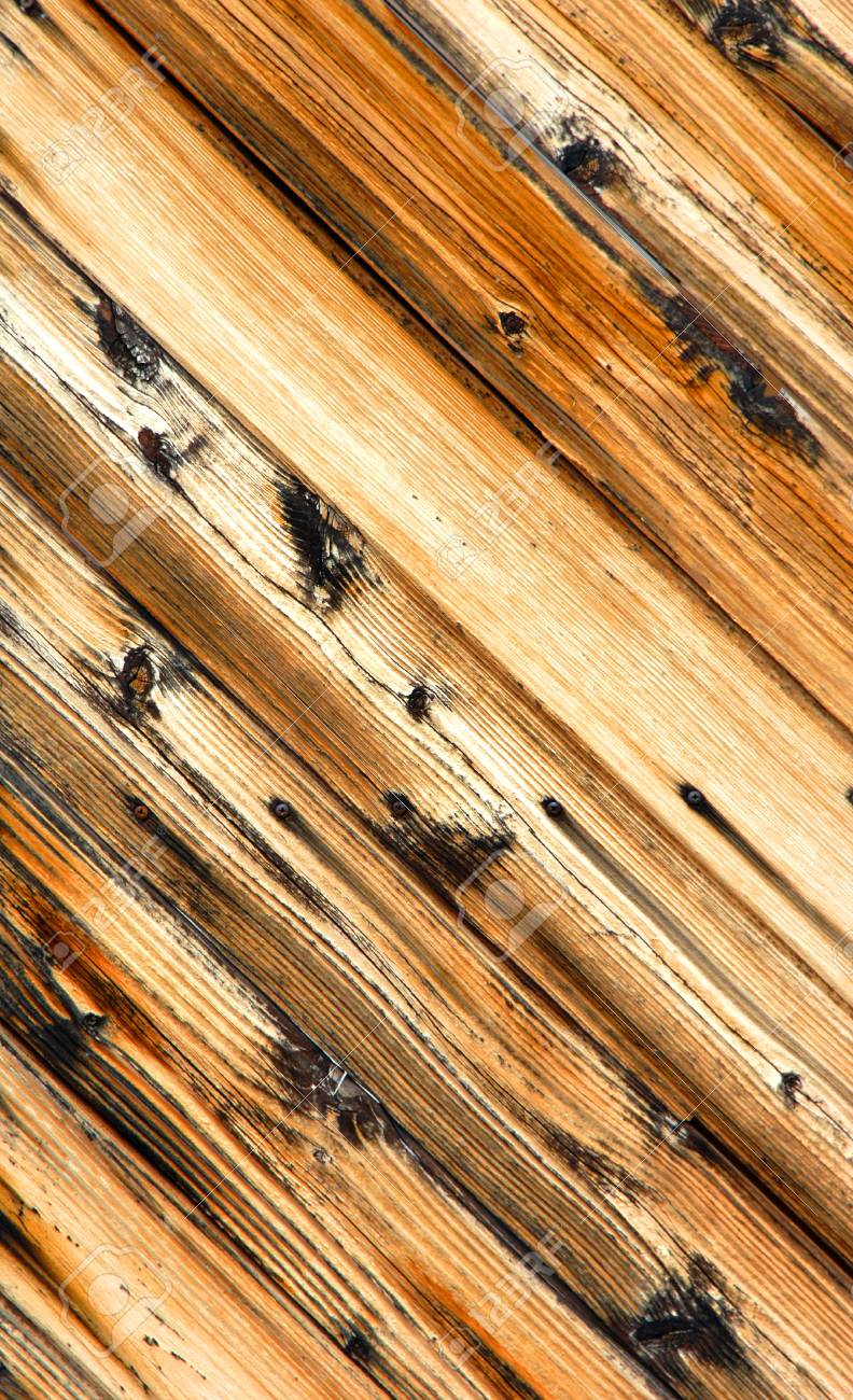 angled wooden door has slanted boards complete with knots wood