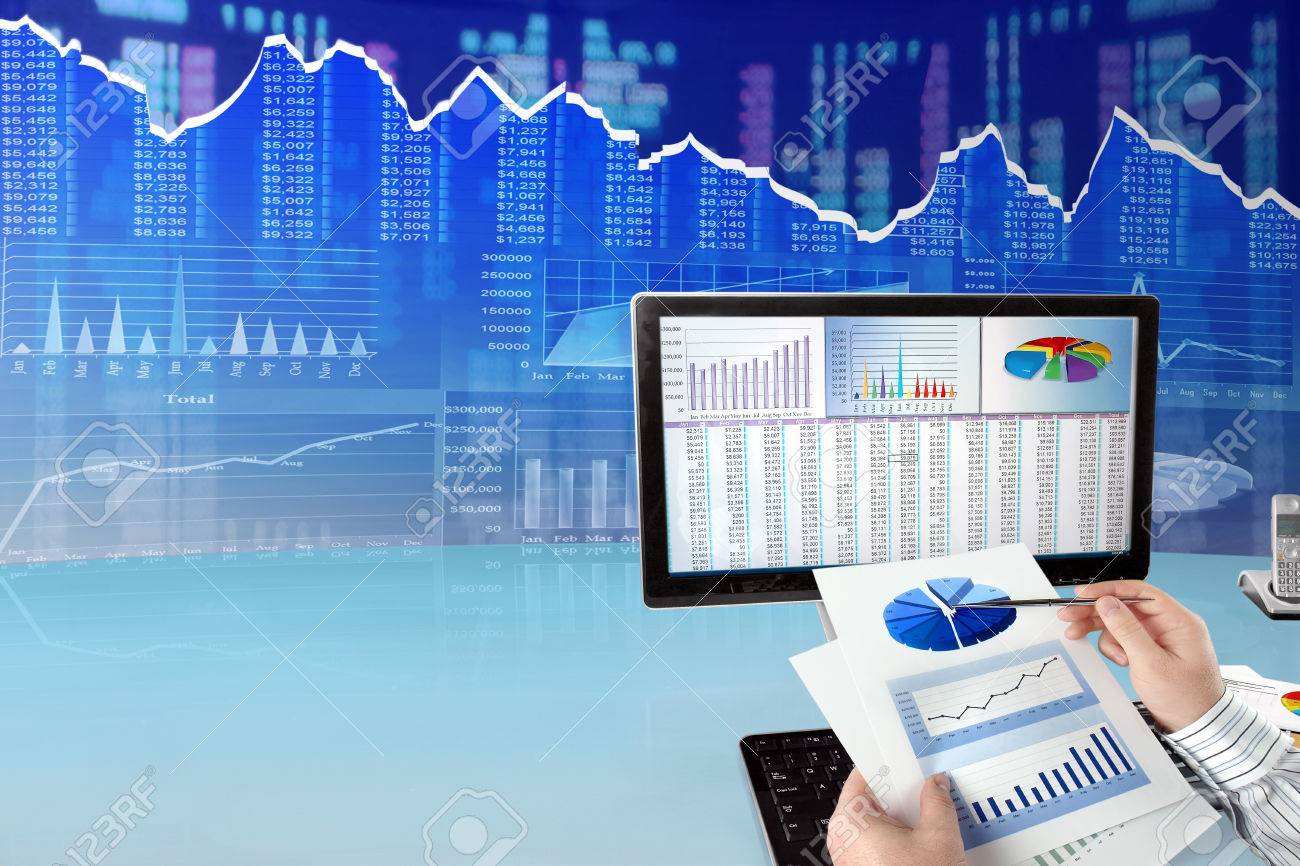 Man Analyzing Financial Data And Charts On Computer - 