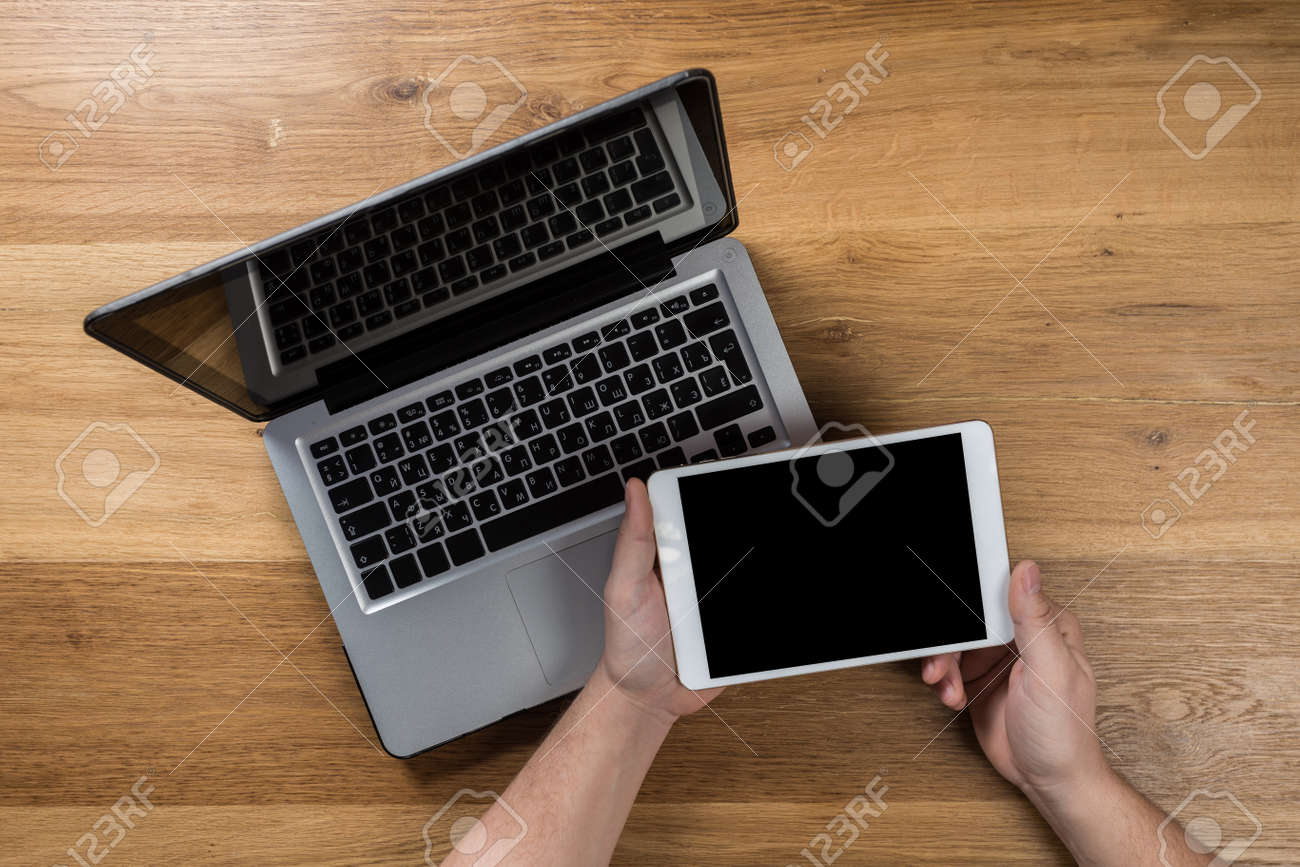 Working on laptop. man working on computer. Top view of person in modern office interior. - 120418462 Working on laptop. man working on computer. Top view of person in modern office interior. - 120418462